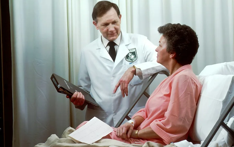 Doctor reviewing results with a patient in hospital